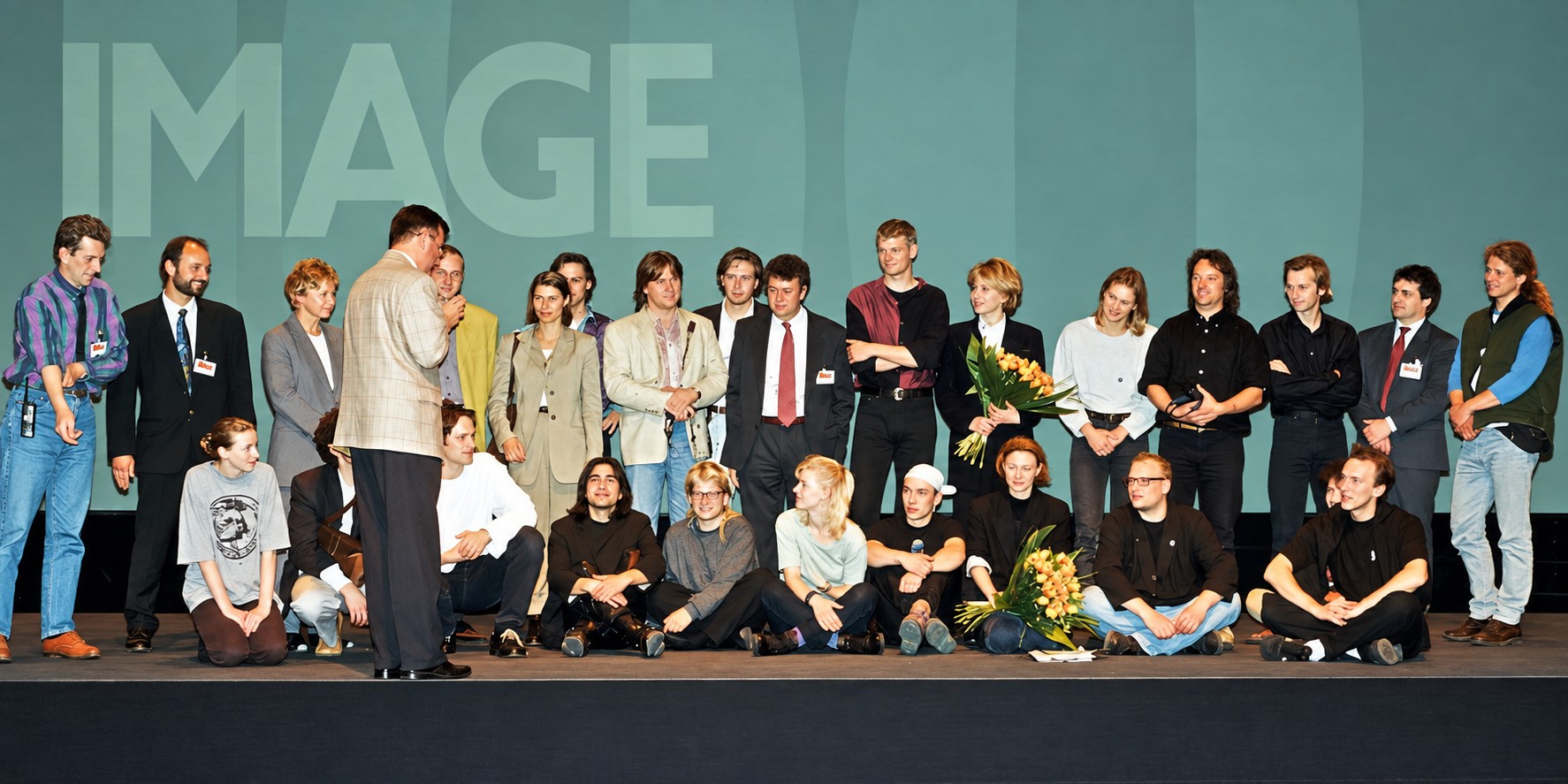 Production team on the IMAGE 100 stage after the Schering event; Anthony G. Morris stands near centre wearing a red tie